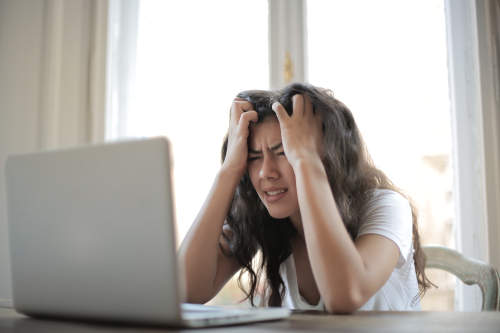 Person looking frustrated with a computer